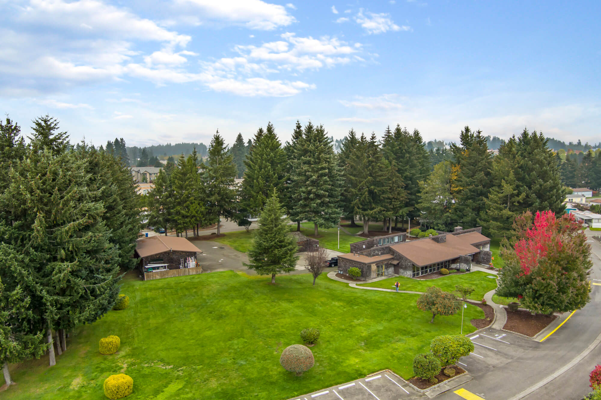 Aerial view of a manufactured home community surrounded by natural spaces.